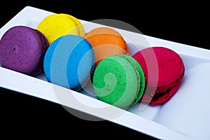 Colored macaroons on a white plate
