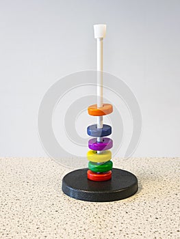 Colored magnetic rings around a rod float above each other