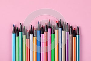 Colored markers without caps isolated on pink background