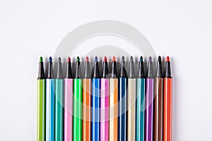 Colored markers without caps isolated on pink background