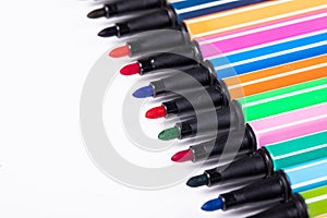 Colored markers without caps isolated on pink background