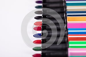 Colored markers without caps isolated on white background