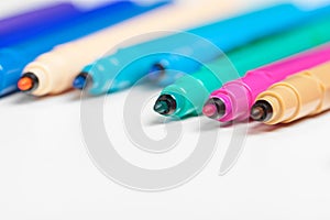 Colored markers isolated on white background. Close up.