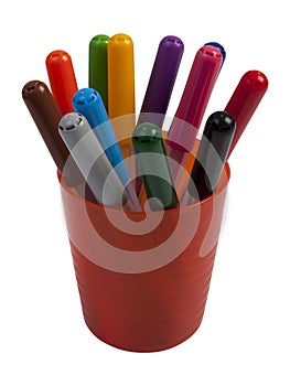 Colored markers in a orange colored plastic cups isolated on white