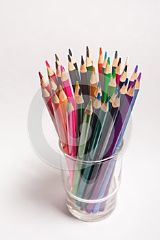 Colored multi color wood pencils in glass isolated