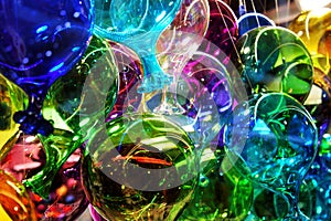 Colored murano glass balloons displayed in one of the many glass objects shops in venice.