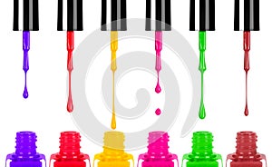 Colored nail polishes dripping from brush into bottle photo