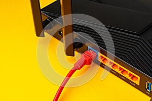 Colored network cable patch-cord on yellow background