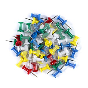 Colored office pins heap on white, top view