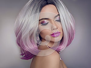 Colored Ombre hair extensions. Beauty Model Girl blonde with short bob purple hairstyle isolated on gray background. Closeup photo