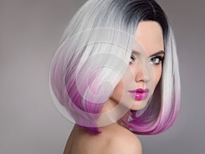 Colored Ombre hair extensions. Beauty Model Girl blonde with short bob purple hairstyle isolated on gray background. Closeup