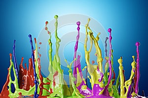 Colored paint splashes on blue background