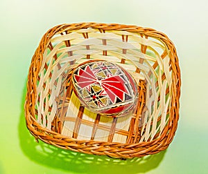 Colored painted romanian traditional Easter eggs in a rustic (vintage) basket, close up