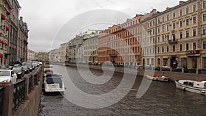 Colored palaces on the river with a boat in St. Petersburg