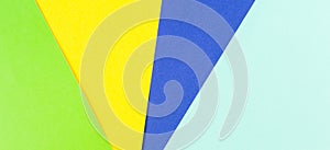 Colored papers composition banner background with yellow, green and blue tones