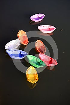 Colored paper boats on the lake