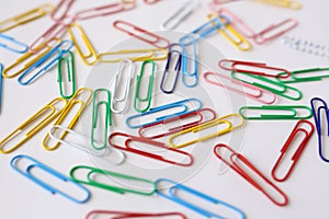 Colored paper clips close-up  on a white background
