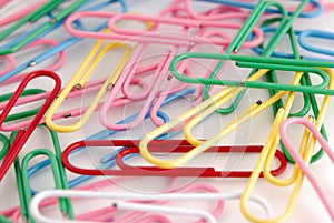 Colored paper clips on white