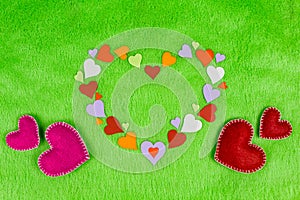 Colored paper hearts on a green cloth