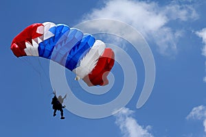 Colored parachute on blue sky