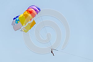 Colored parasail wing in the blue sky, Parasailing also known as parascending or parakiting