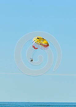 Colored parasail wing pulled by a boat in the sea water