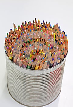 crayons in the metal jar on white background photo