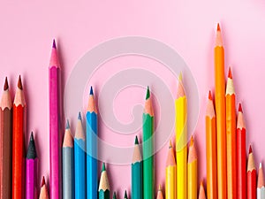 Colored pencil on pink paper background for drawing color circle