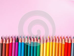 Colored pencil on pink paper background for drawing color circle