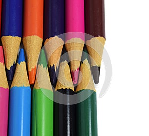 Colored pencils arranged head to head isolated on a white background. copy paste space