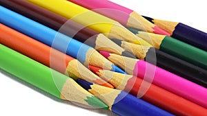 Colored pencils arranged head to head isolated on a white background. copy paste space