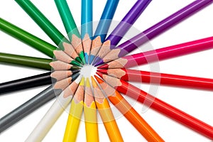 Colored pencils arranged in a star on white background