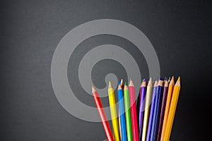 Colored pencils on blackboard background