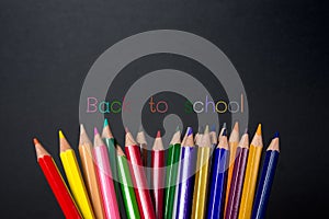 Colored pencils on blackboard background