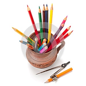 Colored pencils in a clay jug