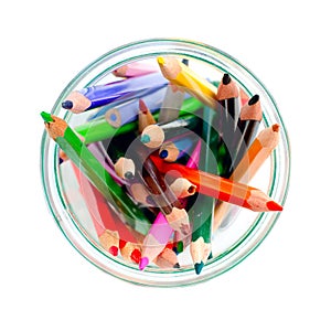 Colored pencils in a clear glass jar. top view