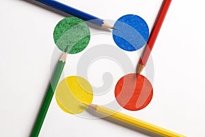 Colored pencils on colored disks arranged as a crossroads