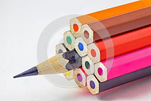 Colored pencils, ends are not sharpened, dark blue pencil sharpened, on white background, selective focus