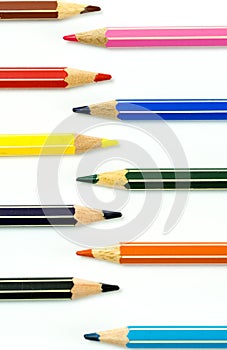 Colored pencils facing each other on a white background