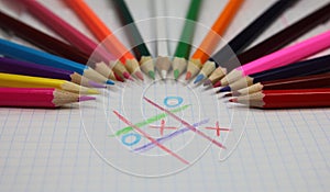 Colored pencils and game crosses and zeroes