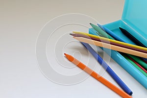 Colored pencils in a light blue pencil case