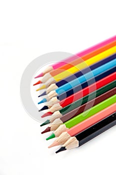 Colored pencils lined up on a white background