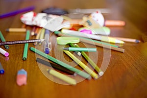 Colored pencils in mess on table