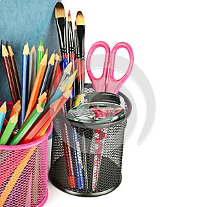 Colored pencils and other school supplies isolated on white . Free space for text