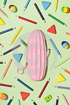 Colored Pencils with pink pencil case background pattern. Back to School