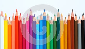 Colored pencils row with wave on white background photo