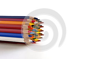 Colored pencils of the same size on white background