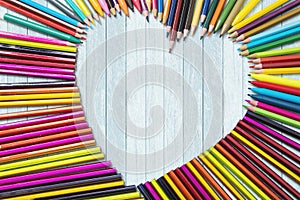 Colored pencils shaped heart symbol