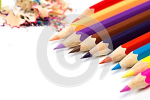 Colored pencils and shavings with pencils. Sharpener of pencils on a white background