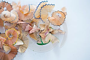 Colored pencils shavings on a white background